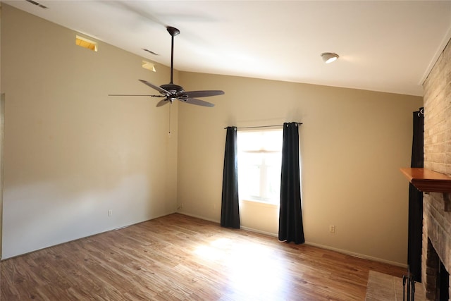 6416 Dawnridge Dr, Houston, TX 77035 - unfurnished living room with vaulted ceiling, wood finished floors, ceiling fan, and a brick fireplace