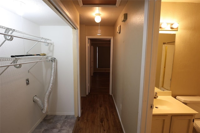 6416 Dawnridge Dr, Houston, TX 77035 - hallway featuring a sink, baseboards, and dark wood-type flooring