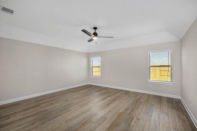 2921 Fair Wind Ln, Texas City, TX 77510 - spare room featuring wood finished floors, ceiling fan, baseboards, and lofted ceiling