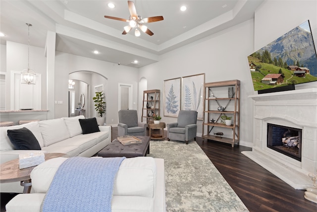 127 Evening Tide Ct, Conroe, TX 77318 - living area featuring arched walkways, a ceiling fan, recessed lighting, dark wood-type flooring, and a raised ceiling