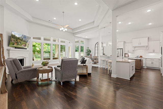 127 Evening Tide Ct, Conroe, TX 77318 - living area featuring ceiling fan, a fireplace, recessed lighting, dark wood finished floors, and a towering ceiling