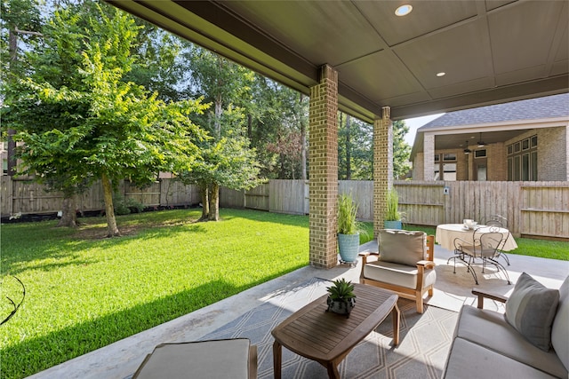 127 Evening Tide Ct, Conroe, TX 77318 - fenced backyard with a patio and an outdoor hangout area