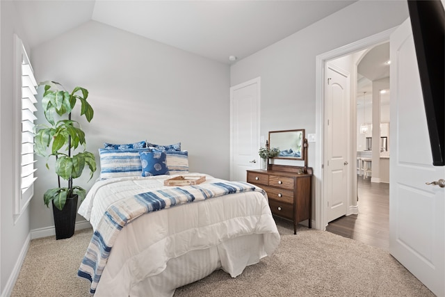 127 Evening Tide Ct, Conroe, TX 77318 - carpeted bedroom with baseboards, lofted ceiling, and arched walkways