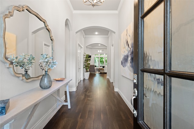 127 Evening Tide Ct, Conroe, TX 77318 - entrance foyer with arched walkways, crown molding, dark wood-style flooring, baseboards, and a chandelier