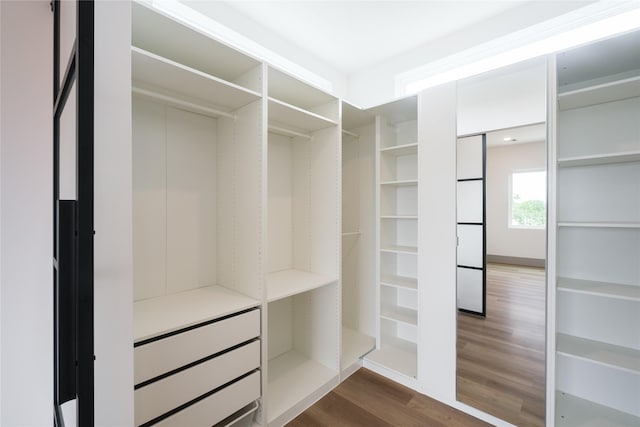 1053 W 15th 1/2 St, Houston, TX 77008 - walk in closet with dark wood-style flooring