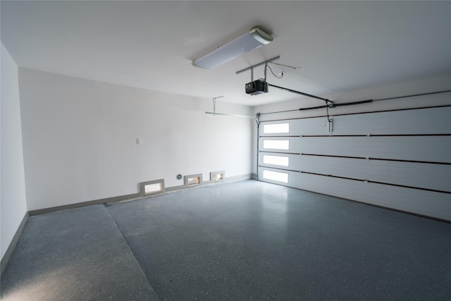 1053 W 15th 1/2 St, Houston, TX 77008 - garage featuring a garage door opener and baseboards