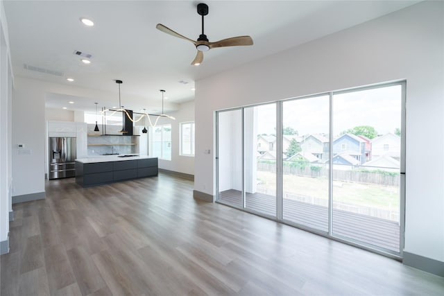 1053 W 15th 1/2 St, Houston, TX 77008 - living area featuring recessed lighting, ceiling fan, wood finished floors, and a chandelier
