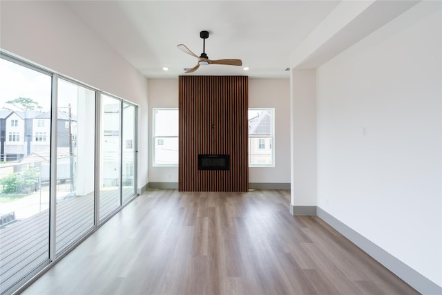 1053 W 15th 1/2 St, Houston, TX 77008 - unfurnished living room featuring ceiling fan, healthy amount of natural light, light wood-style floors, recessed lighting, and a glass covered fireplace
