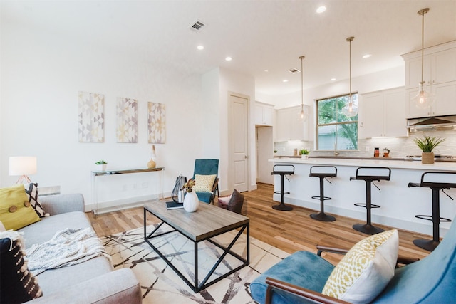 1414 Wichman St, Houston, TX 77007 - living room featuring light wood-style floors and recessed lighting