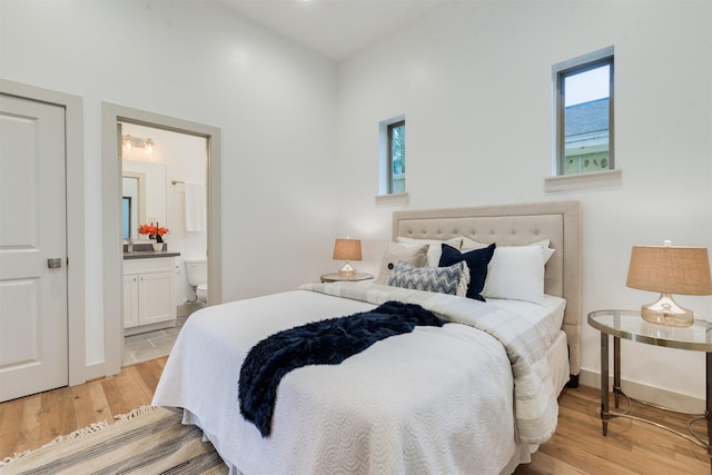 1414 Wichman St, Houston, TX 77007 - bedroom with light wood-style flooring and ensuite bathroom