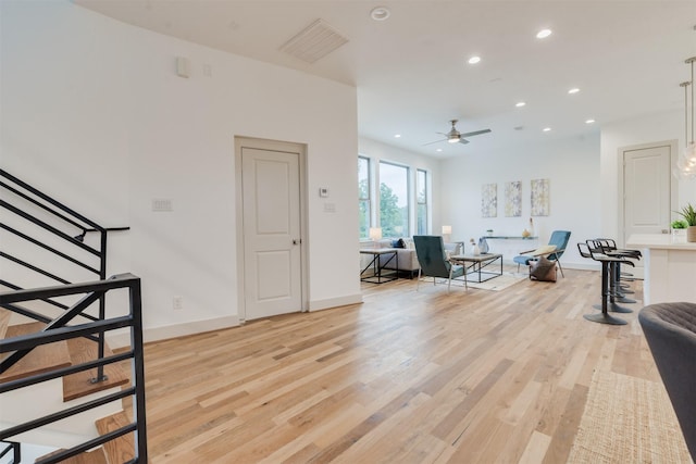 1414 Wichman St, Houston, TX 77007 - living room with light wood-type flooring, recessed lighting, stairs, a ceiling fan, and baseboards
