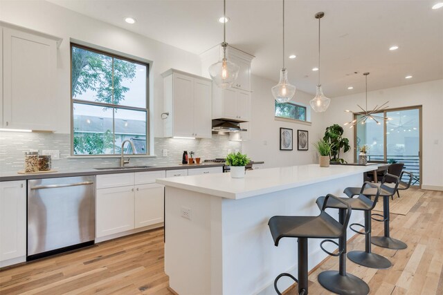 1414 Wichman St, Houston, TX 77007 - kitchen with dishwasher, a sink, light wood finished floors, recessed lighting, and tasteful backsplash