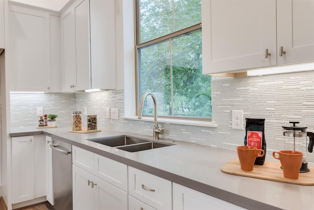 1414 Wichman St, Houston, TX 77007 - kitchen featuring a sink, light countertops, white cabinets, and decorative backsplash