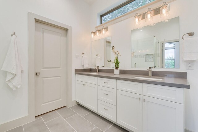 1414 Wichman St, Houston, TX 77007 - full bathroom featuring double vanity, tile patterned floors, and a stall shower