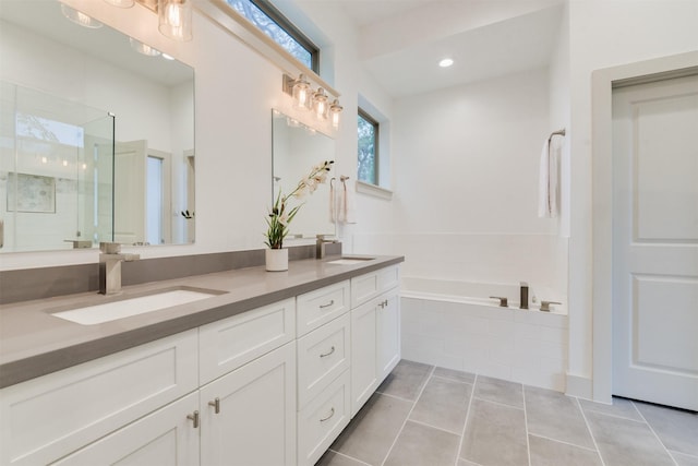 1414 Wichman St, Houston, TX 77007 - full bath featuring a stall shower, double vanity, tile patterned flooring, and a garden tub