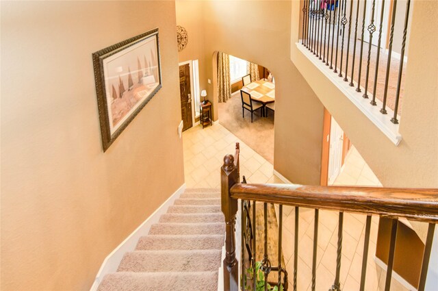 2714 San Marco Ln, League City, TX 77573 - staircase featuring baseboards, carpet, and tile patterned floors