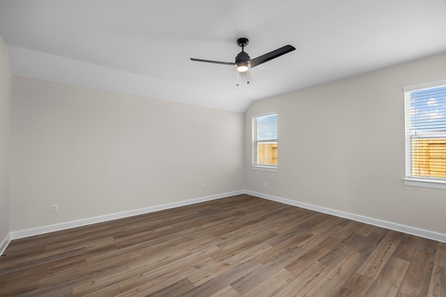 14005 Starboard Reach Dr, Texas City, TX 77510 - spare room featuring dark wood-style floors, a ceiling fan, baseboards, and vaulted ceiling