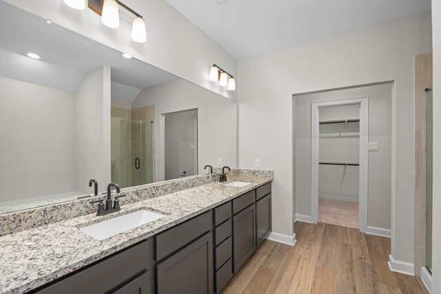 14005 Starboard Reach Dr, Texas City, TX 77510 - full bath with a shower stall, a spacious closet, double vanity, wood finished floors, and baseboards