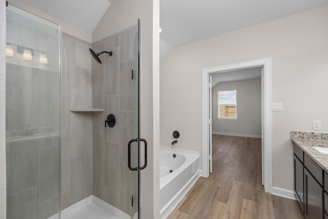 14005 Starboard Reach Dr, Texas City, TX 77510 - bathroom featuring vaulted ceiling, a stall shower, vanity, a bath, and wood finished floors