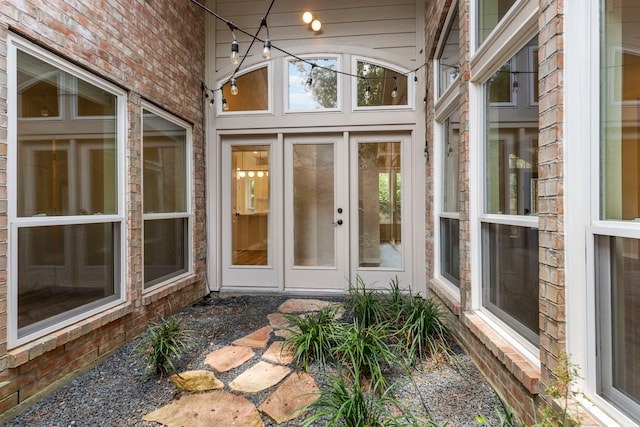 15 Prism Cove Pl, The Woodlands, TX 77381 - unfurnished sunroom featuring brick wall and high vaulted ceiling