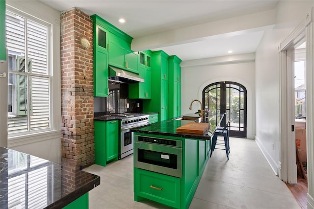 1416 Rosenberg St, Galveston, TX 77550 - kitchen featuring green cabinets, stainless steel range with gas cooktop, under cabinet range hood, and beamed ceiling