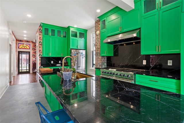 1416 Rosenberg St, Galveston, TX 77550 - kitchen featuring under cabinet range hood, appliances with stainless steel finishes, green cabinetry, a sink, and decorative backsplash