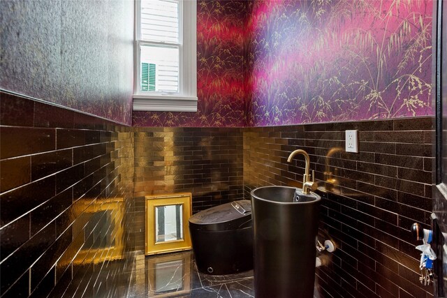 1416 Rosenberg St, Galveston, TX 77550 - bathroom featuring wallpapered walls, tile walls, and a wainscoted wall