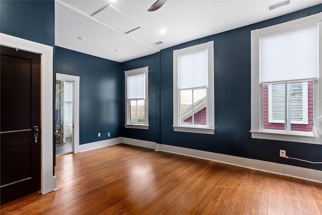 1416 Rosenberg St, Galveston, TX 77550 - empty room with attic access, hardwood / wood-style flooring, and baseboards