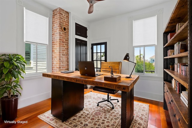 1416 Rosenberg St, Galveston, TX 77550 - office area featuring baseboards, plenty of natural light, and wood finished floors