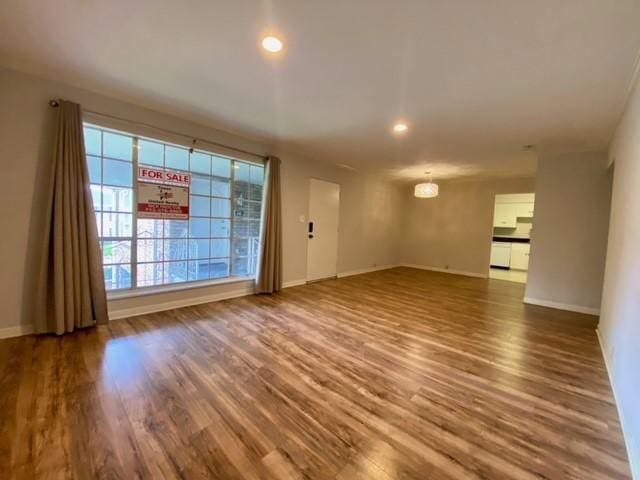 2121 Fountain View Dr Unit 8, Houston, TX 77057 - unfurnished living room featuring wood finished floors, baseboards, and recessed lighting