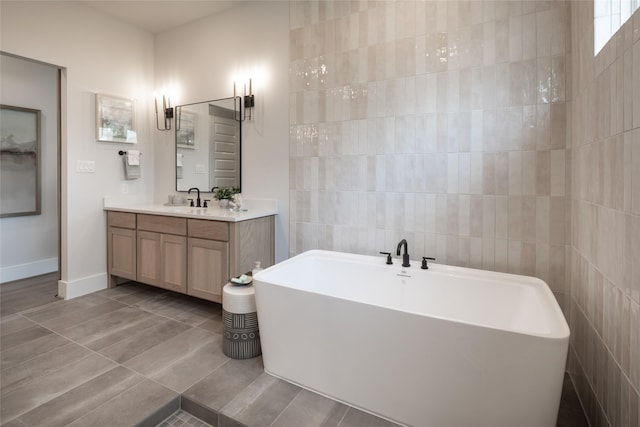 21742 Grayson Highlands Way, Porter Heights, TX 77365 - bathroom with a freestanding tub, vanity, tile patterned floors, and baseboards