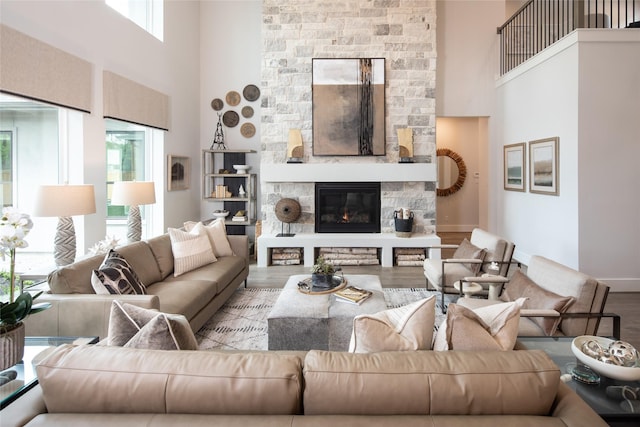 21742 Grayson Highlands Way, Porter Heights, TX 77365 - living area with a high ceiling, wood finished floors, a stone fireplace, and baseboards
