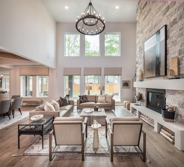 21742 Grayson Highlands Way, Porter Heights, TX 77365 - living area with a towering ceiling, wood finished floors, a chandelier, and a fireplace