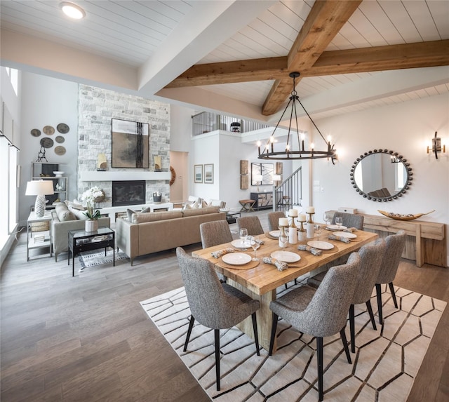 21742 Grayson Highlands Way, Porter Heights, TX 77365 - dining area with a chandelier, light wood-type flooring, wood ceiling with exposed beams, and a fireplace