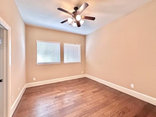 10410 Hatcher Dr, Katy, TX 77494 - spare room with dark wood finished floors, ceiling fan, and baseboards