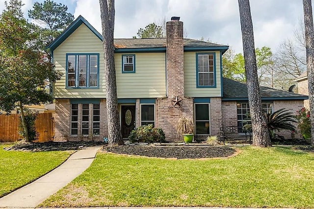 17719 Windy Point Dr, Spring, TX 77379 - view of front of house with brick siding, a chimney, and roof with shingles
