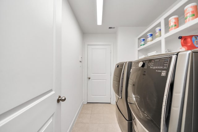 14006 Alex Landing Dr, Humble, TX 77396 - laundry area with washing machine and dryer, light tile patterned flooring, and baseboards
