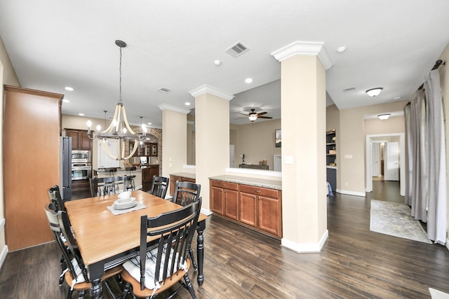 14006 Alex Landing Dr, Humble, TX 77396 - dining space with ornate columns, ceiling fan, a chandelier, dark wood-style floors, and baseboards