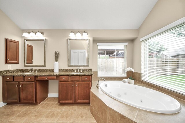 14006 Alex Landing Dr, Humble, TX 77396 - full bathroom with double vanity, a tub with jets, lofted ceiling, and tile patterned floors