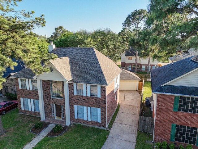 16403 Wellers Way, Houston, TX 77095 - view of front facade with a chimney, a garage, brick siding, central air condition unit, and a shingled roof