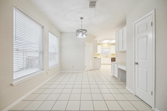 16403 Wellers Way, Houston, TX 77095 - unfurnished dining area featuring a chandelier, baseboards, light tile patterned floors, and a sink