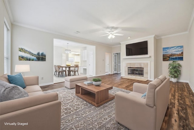 16403 Wellers Way, Houston, TX 77095 - living area with baseboards, wood finished floors, ornamental molding, ceiling fan, and a tiled fireplace