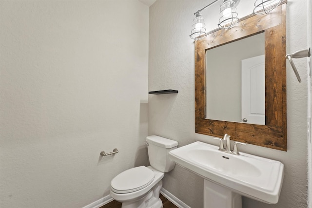 4430 Lone Alcove Dr, Spring, TX 77386 - bathroom with toilet, baseboards, wood finished floors, a textured wall, and a sink
