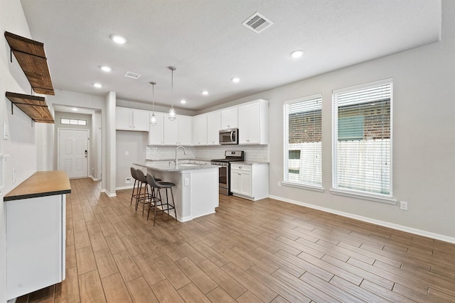 4430 Lone Alcove Dr, Spring, TX 77386 - kitchen featuring appliances with stainless steel finishes, a sink, healthy amount of natural light, baseboards, and recessed lighting
