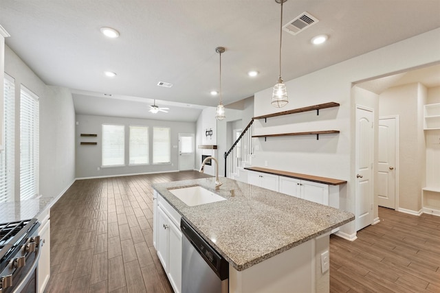 4430 Lone Alcove Dr, Spring, TX 77386 - kitchen featuring stainless steel appliances, a sink, wood finished floors, white cabinets, and decorative light fixtures