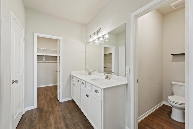 4430 Lone Alcove Dr, Spring, TX 77386 - full bathroom with hardwood / wood-style floors, toilet, a spacious closet, double vanity, and baseboards