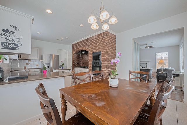 211 Aberdeen St, Stafford, TX 77477 - dining space featuring a fireplace, light tile patterned floors, ceiling fan, a chandelier, and recessed lighting