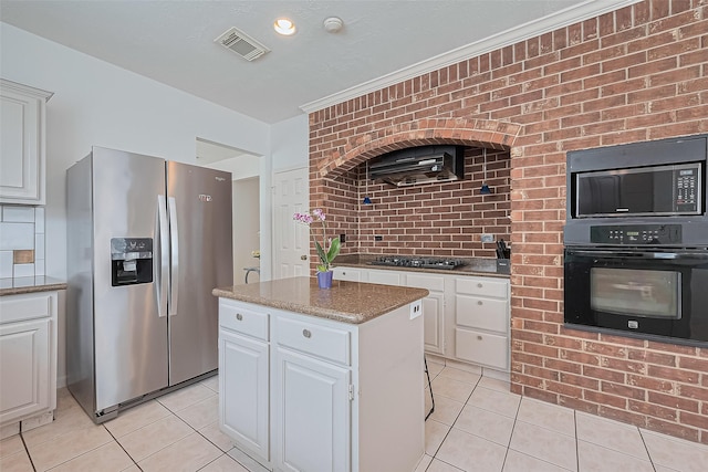 211 Aberdeen St, Stafford, TX 77477 - kitchen featuring stainless steel refrigerator with ice dispenser, oven, light tile patterned floors, and gas cooktop