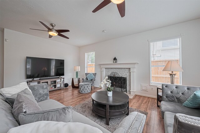 211 Aberdeen St, Stafford, TX 77477 - living area featuring ceiling fan, wood finished floors, and a fireplace with raised hearth