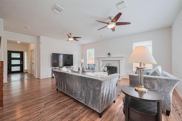 211 Aberdeen St, Stafford, TX 77477 - living room featuring a ceiling fan, wood finished floors, and a fireplace